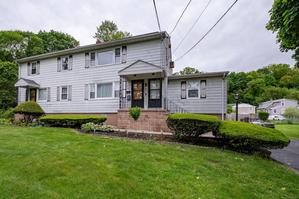 42 Milton St, New Haven, CT 06513 - view of front of property with a front lawn and a chimney