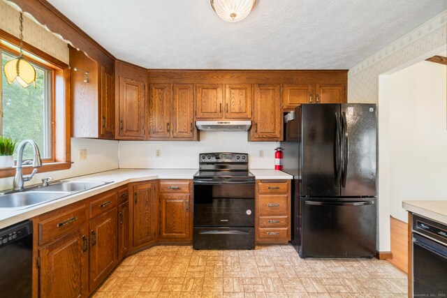 15 Shingle Mill Rd, Bristol, CT 06010 - kitchen with black appliances, a sink, wallpapered walls, light countertops, and brown cabinets