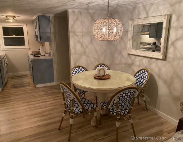 2 Dilliston Rd, Barkhamsted, CT 06063 - dining area with baseboards, light wood-style floors, and a chandelier