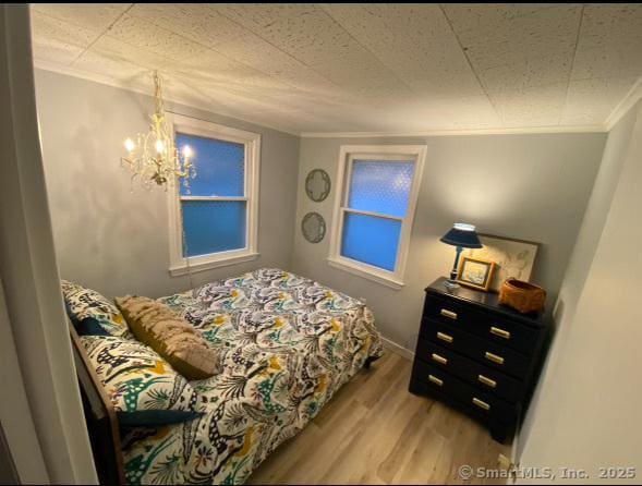 2 Dilliston Rd, Barkhamsted, CT 06063 - bedroom with ornamental molding, light wood finished floors, and a chandelier