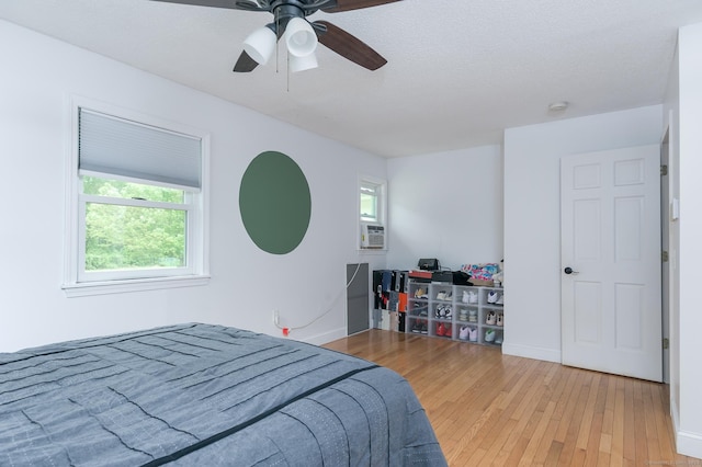 104 E St, Hebron, CT 06248 - bedroom with wood-type flooring, ceiling fan, baseboards, and cooling unit