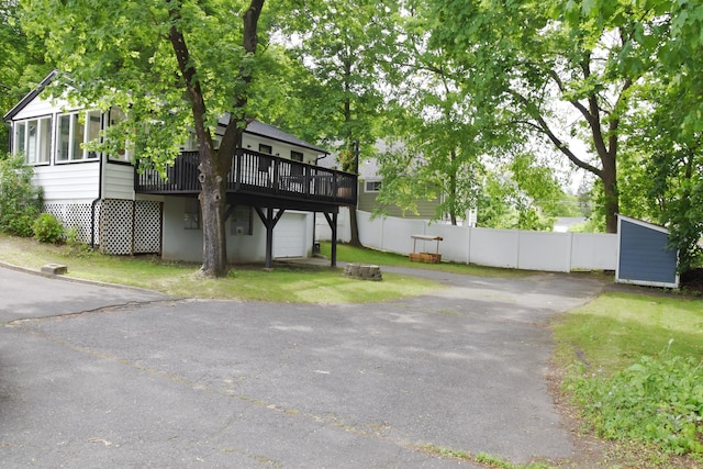40 Mountainville Rd, Danbury, CT 06810 - view of front of property featuring a wooden deck, asphalt driveway, an attached garage, and a sunroom