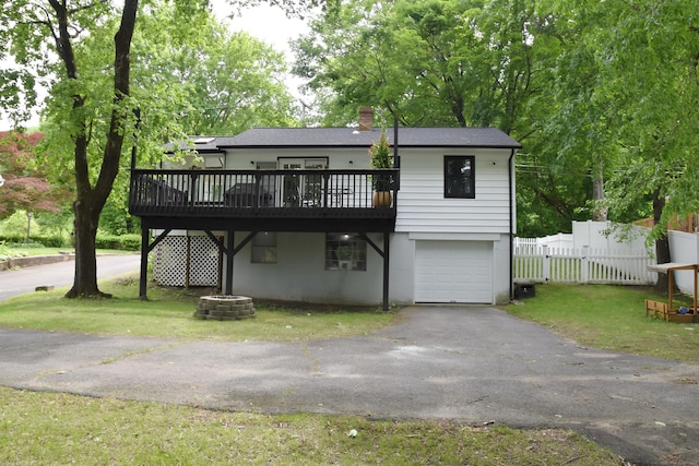 40 Mountainville Rd, Danbury, CT 06810 - view of front facade with a garage, a wooden deck, driveway, a chimney, and a gate