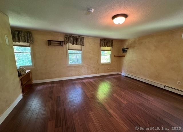149 Mill Hill Rd, Colchester, CT 06415 - empty room with baseboards, dark wood-style floors, and a baseboard radiator