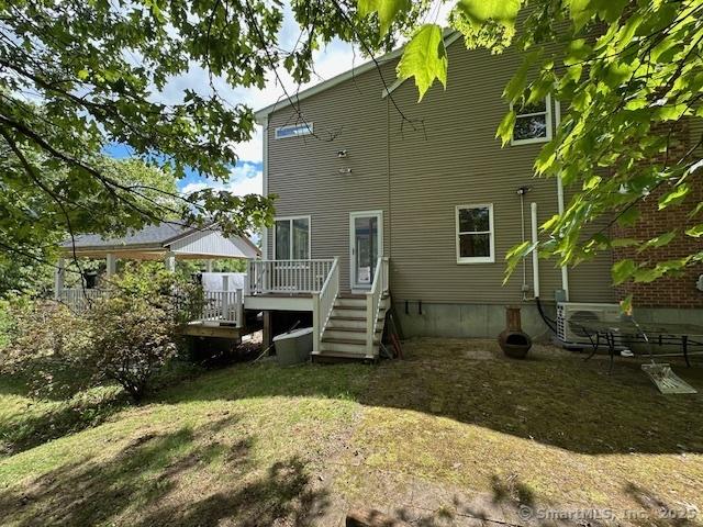 149 Mill Hill Rd, Colchester, CT 06415 - back of property featuring a deck, stairs, and a lawn