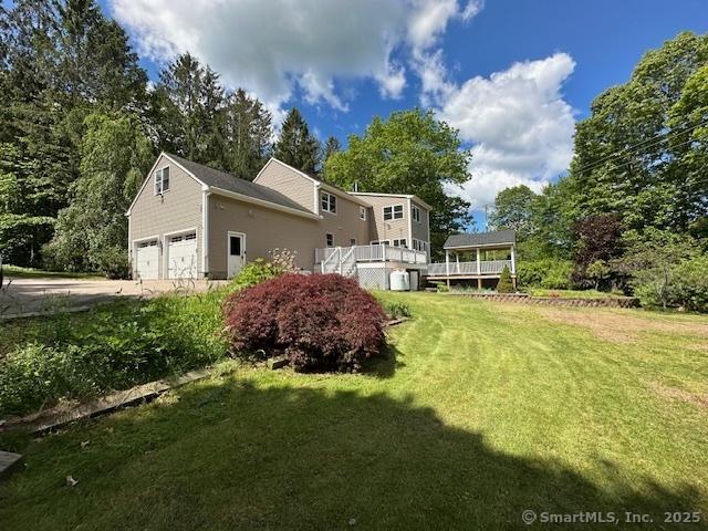 149 Mill Hill Rd, Colchester, CT 06415 - view of grassy yard with driveway and a wooden deck