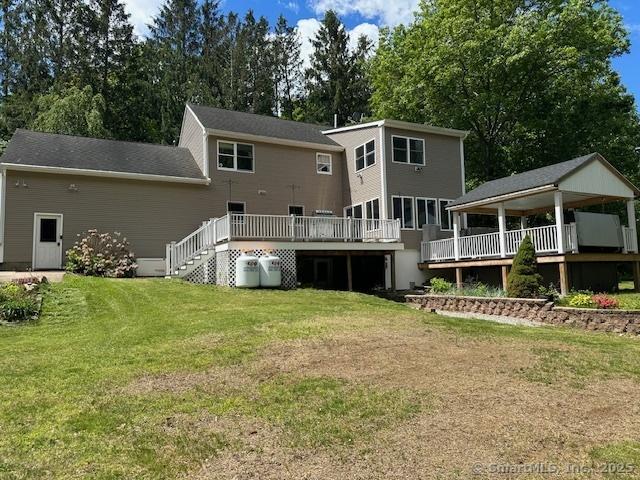 149 Mill Hill Rd, Colchester, CT 06415 - rear view of property with a wooden deck and a lawn