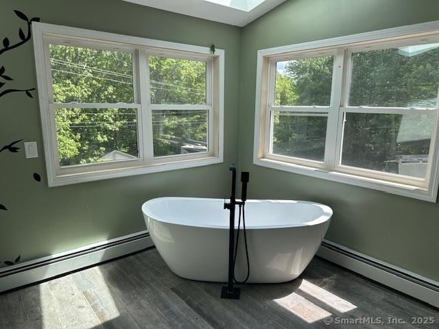 149 Mill Hill Rd, Colchester, CT 06415 - bathroom featuring baseboard heating, a freestanding tub, and wood finished floors