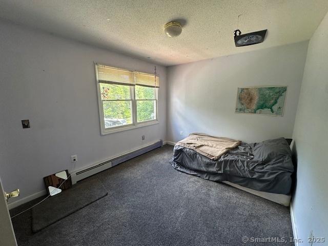 149 Mill Hill Rd, Colchester, CT 06415 - carpeted bedroom with baseboard heating, a textured ceiling, and baseboards