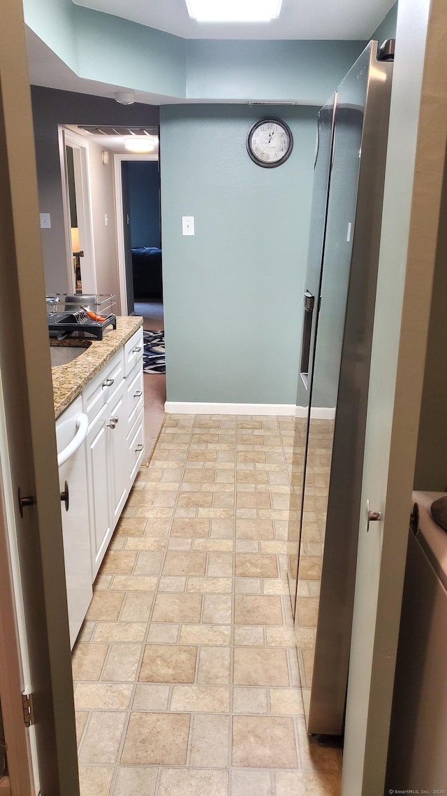 71 Leafwood Ln Unit 294, Groton, CT 06340 - kitchen featuring white cabinets, light stone countertops, and white dishwasher