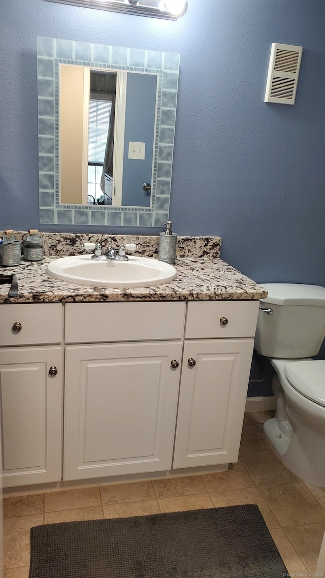 71 Leafwood Ln Unit 294, Groton, CT 06340 - bathroom with toilet, vanity, and tile patterned flooring