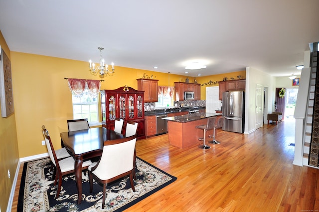 49 Shepard Way Unit 49, South Windsor, CT 06074 - dining space with a chandelier, light wood-style floors, and baseboards
