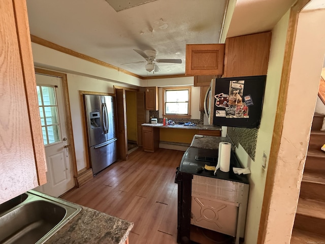 81 Melrose Dr, New Haven, CT 06513 - kitchen with stainless steel fridge, brown cabinetry, light wood-style floors, a ceiling fan, and a baseboard radiator