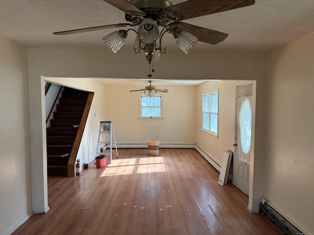 81 Melrose Dr, New Haven, CT 06513 - entryway with baseboard heating, ceiling fan, wood finished floors, stairway, and a textured ceiling