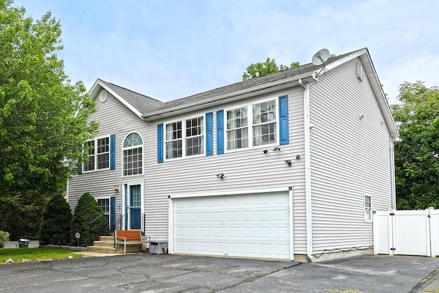 354 Lynne Pl, Bridgeport, CT 06610 - view of front of home with a garage, asphalt driveway, and a gate