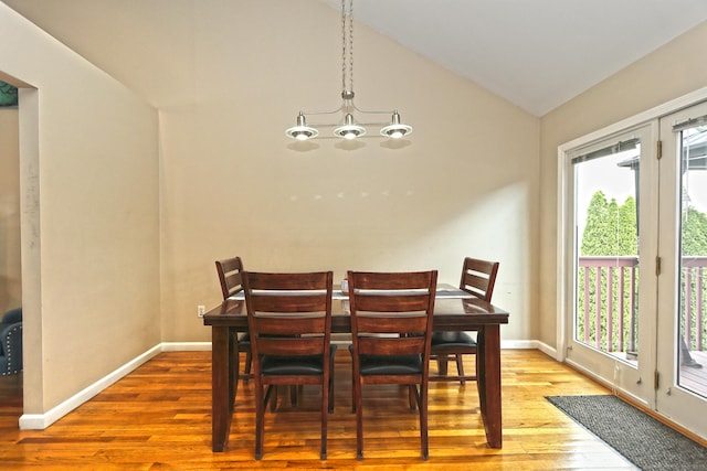 354 Lynne Pl, Bridgeport, CT 06610 - dining room featuring plenty of natural light, vaulted ceiling, wood finished floors, a chandelier, and baseboards
