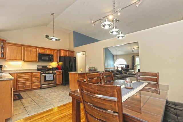 354 Lynne Pl, Bridgeport, CT 06610 - kitchen featuring black appliances, brown cabinets, high vaulted ceiling, hanging light fixtures, and light wood-style flooring