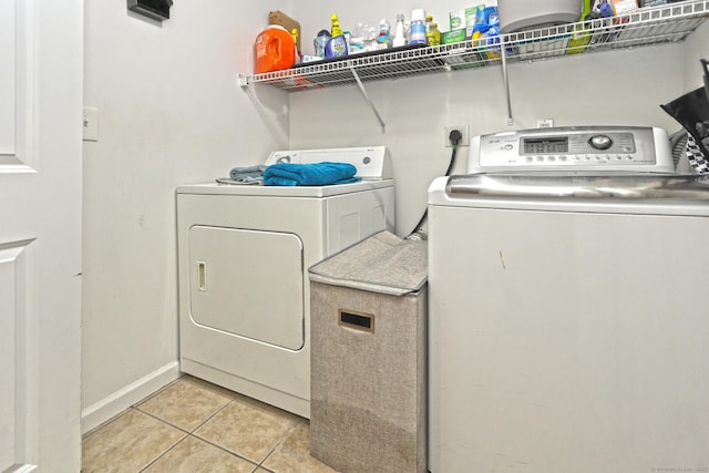 354 Lynne Pl, Bridgeport, CT 06610 - laundry room featuring separate washer and dryer, light tile patterned flooring, and baseboards