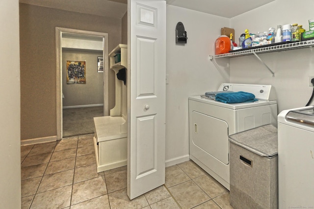 354 Lynne Pl, Bridgeport, CT 06610 - washroom featuring washing machine and dryer, light tile patterned floors, and baseboards