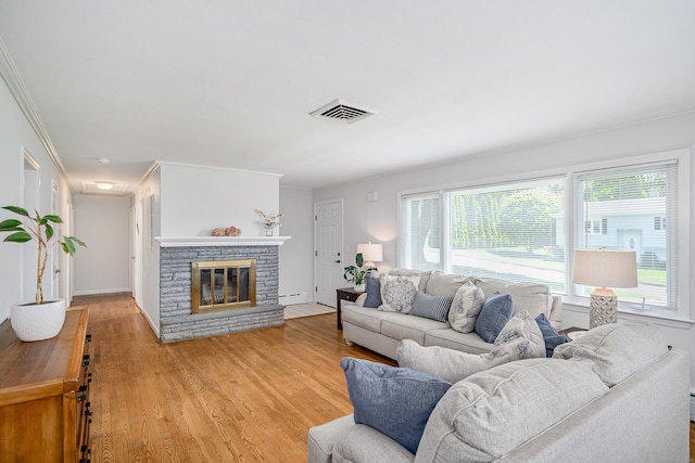 28 Sherry Ln, Danbury, CT 06811 - living room featuring plenty of natural light, light wood-type flooring, a stone fireplace, and crown molding