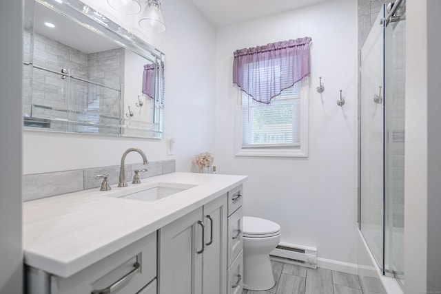 28 Sherry Ln, Danbury, CT 06811 - bathroom with a baseboard heating unit, toilet, vanity, and baseboards