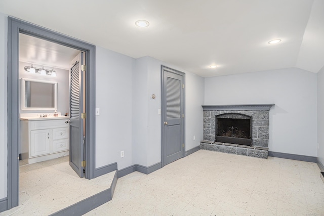 28 Sherry Ln, Danbury, CT 06811 - unfurnished living room featuring baseboards, tile patterned floors, a sink, a stone fireplace, and recessed lighting