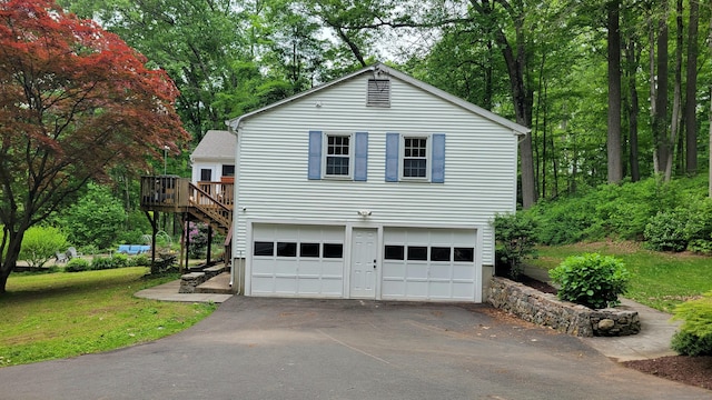 550 W Lake Ave, Guilford, CT 06437 - view of side of home featuring asphalt driveway, a deck, stairs, a yard, and an attached garage