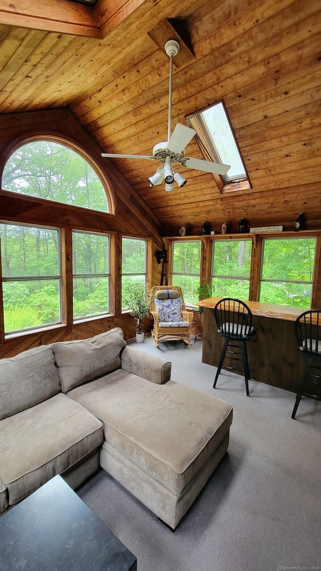550 W Lake Ave, Guilford, CT 06437 - carpeted living room with wooden ceiling, a ceiling fan, vaulted ceiling, and a skylight