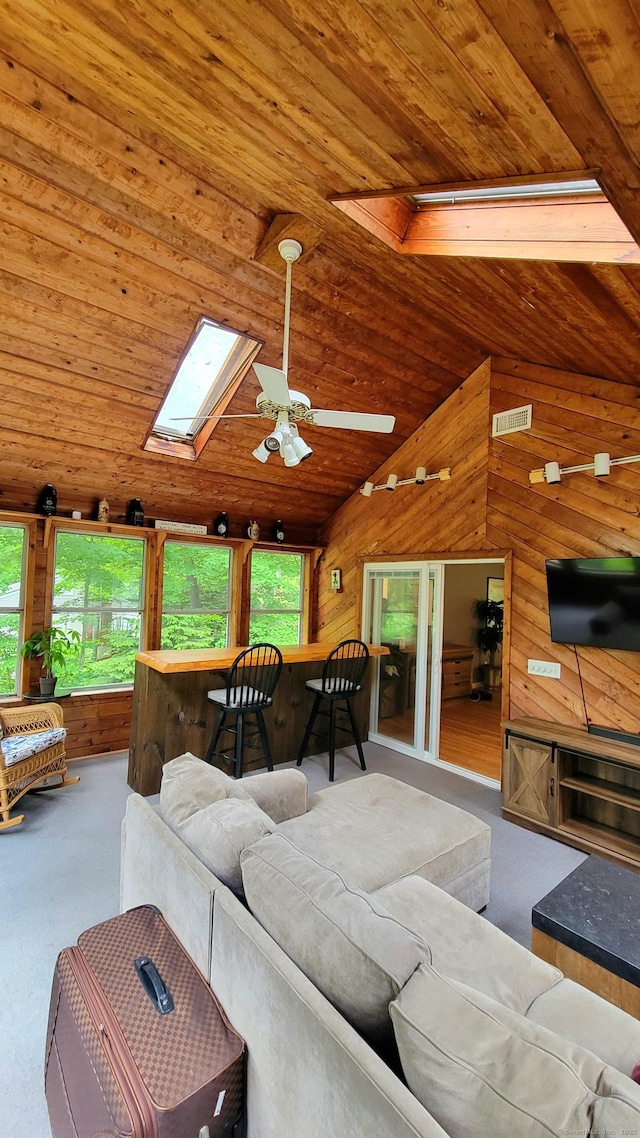 550 W Lake Ave, Guilford, CT 06437 - living area featuring wood ceiling, wood walls, healthy amount of natural light, vaulted ceiling, and a ceiling fan