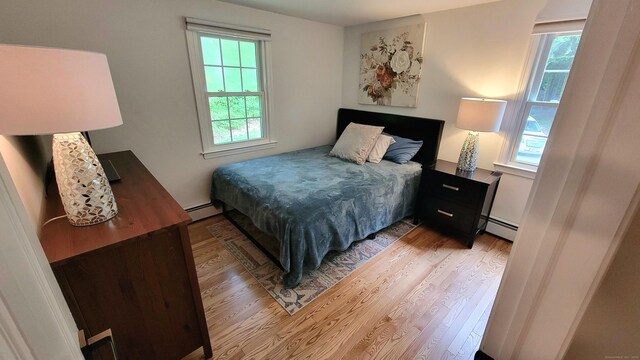 550 W Lake Ave, Guilford, CT 06437 - bedroom featuring light wood-style flooring, multiple windows, and baseboard heating