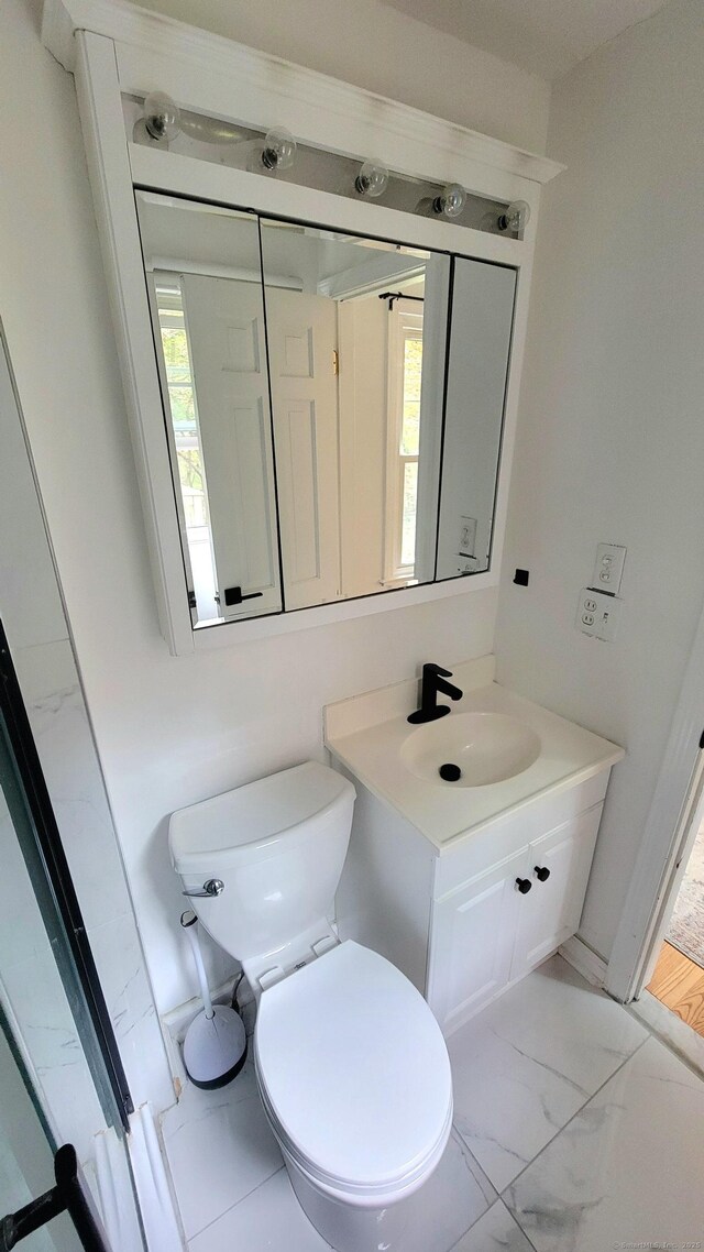 550 W Lake Ave, Guilford, CT 06437 - bathroom with toilet, vanity, and marble finish flooring