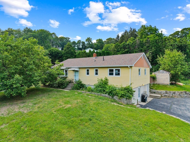 24 Ledgewood Ct, Norwich, CT 06360 - rear view of house with an attached garage, a yard, and asphalt driveway