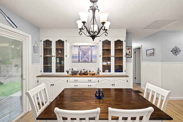 24 Ledgewood Ct, Norwich, CT 06360 - dining space with wainscoting, a chandelier, and light wood finished floors