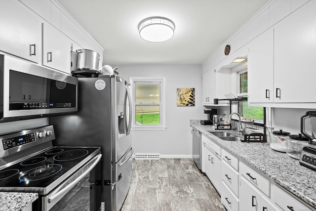 24 Ledgewood Ct, Norwich, CT 06360 - kitchen featuring appliances with stainless steel finishes, white cabinetry, and light stone counters