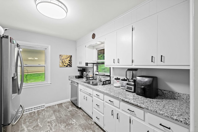 24 Ledgewood Ct, Norwich, CT 06360 - kitchen featuring appliances with stainless steel finishes, white cabinetry, and light stone countertops