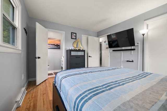 24 Ledgewood Ct, Norwich, CT 06360 - bedroom featuring baseboard heating and light wood-style floors