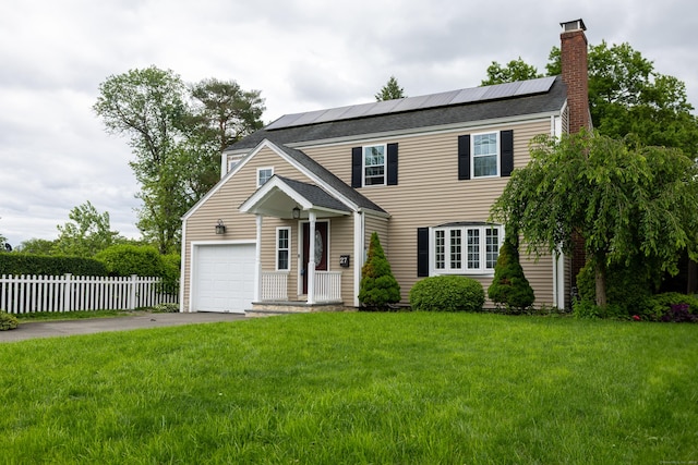 27 Judd Rd, Wethersfield, CT 06109 - view of front facade featuring driveway, an attached garage, a chimney, and roof mounted solar panels