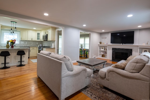 27 Judd Rd, Wethersfield, CT 06109 - living area featuring light wood-style flooring, a high end fireplace, recessed lighting, and baseboards