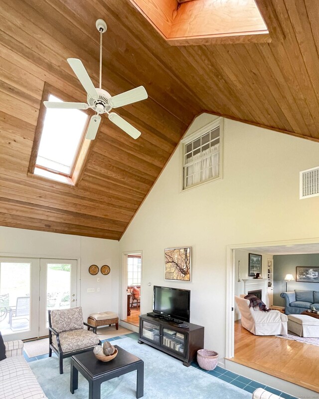 72 Cox Rd, Portland, CT 06480 - tiled living room featuring wood ceiling, ceiling fan, high vaulted ceiling, and a skylight