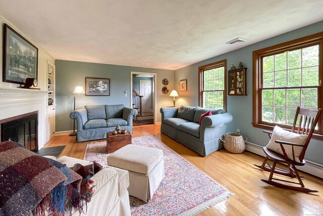 72 Cox Rd, Portland, CT 06480 - living room with wood finished floors, a fireplace with flush hearth, baseboards, and built in features