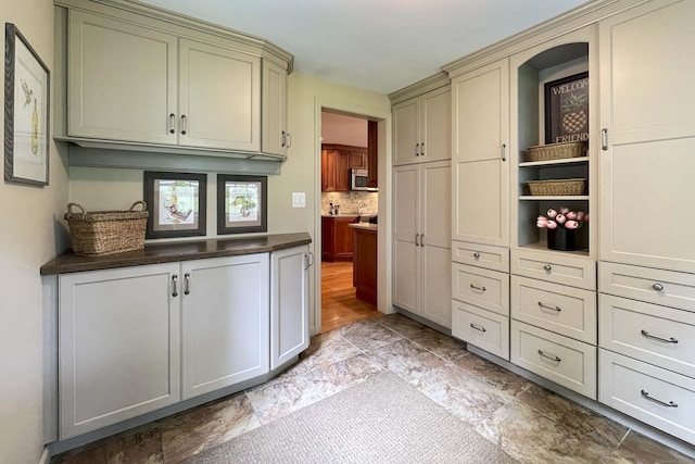 72 Cox Rd, Portland, CT 06480 - kitchen with stainless steel microwave, cream cabinets, dark countertops, and tasteful backsplash