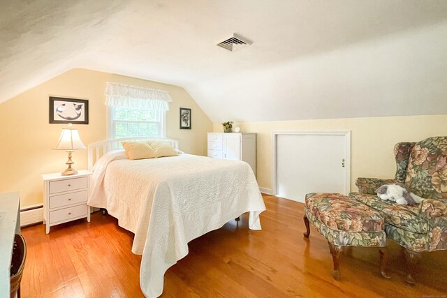72 Cox Rd, Portland, CT 06480 - bedroom with wood finished floors, a baseboard heating unit, and vaulted ceiling