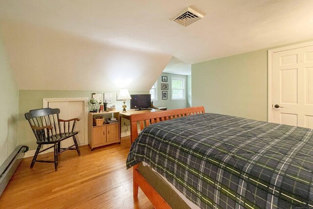 72 Cox Rd, Portland, CT 06480 - bedroom featuring a baseboard heating unit, light wood-type flooring, and vaulted ceiling