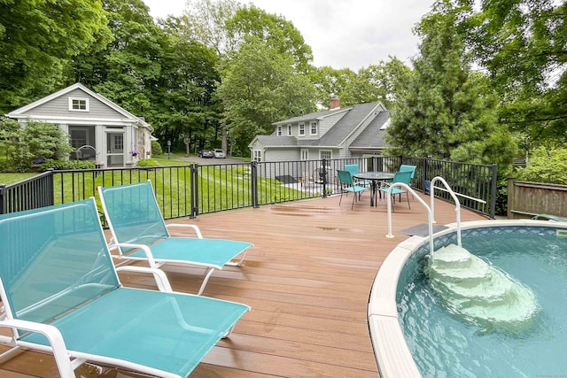 72 Cox Rd, Portland, CT 06480 - wooden terrace featuring outdoor dining area, a yard, view of wooded area, an outbuilding, and an outdoor pool