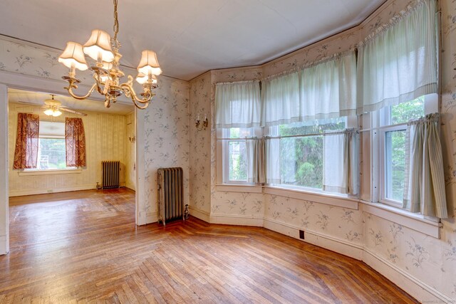 45 Perkins Ave, Norwich, CT 06360 - unfurnished dining area featuring radiator, plenty of natural light, a chandelier, and wallpapered walls