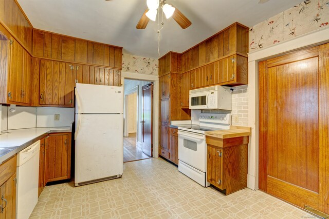 45 Perkins Ave, Norwich, CT 06360 - kitchen with white appliances, light floors, brown cabinetry, and a ceiling fan