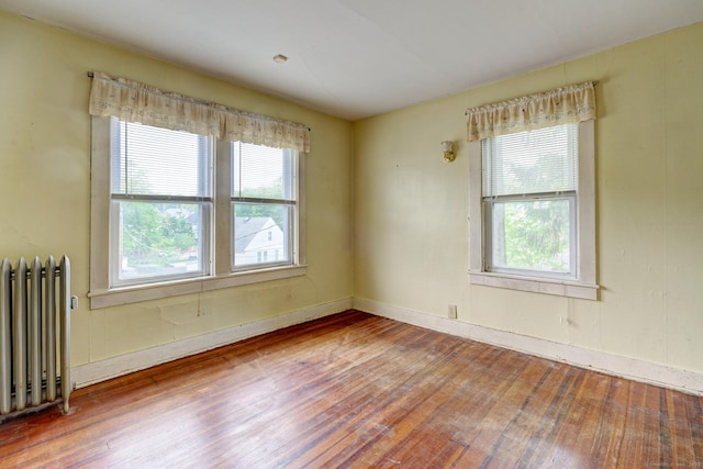 45 Perkins Ave, Norwich, CT 06360 - spare room featuring radiator, hardwood / wood-style flooring, plenty of natural light, and baseboards