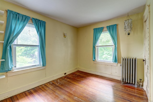 45 Perkins Ave, Norwich, CT 06360 - spare room with radiator, wood finished floors, and baseboards