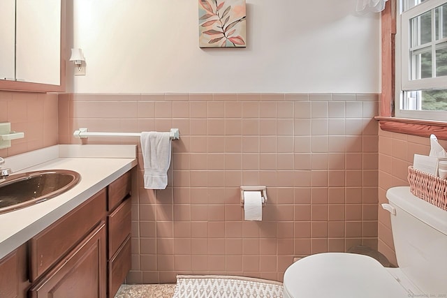 47 Delmont Rd, East Hartford, CT 06108 - half bath featuring tile walls, toilet, vanity, and a wainscoted wall