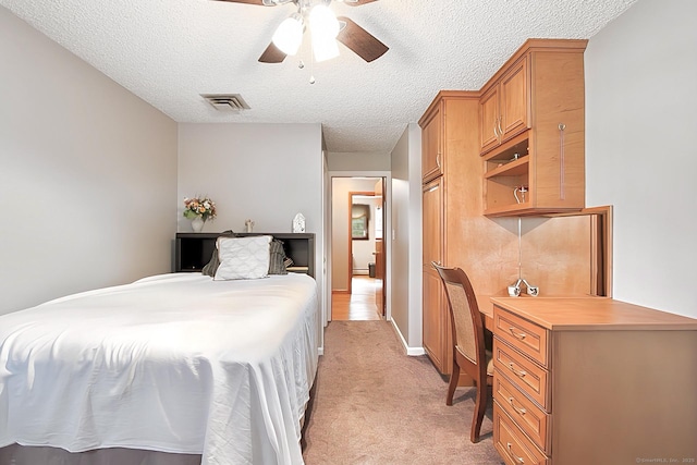 47 Delmont Rd, East Hartford, CT 06108 - bedroom with light colored carpet, a textured ceiling, a desk, and a ceiling fan